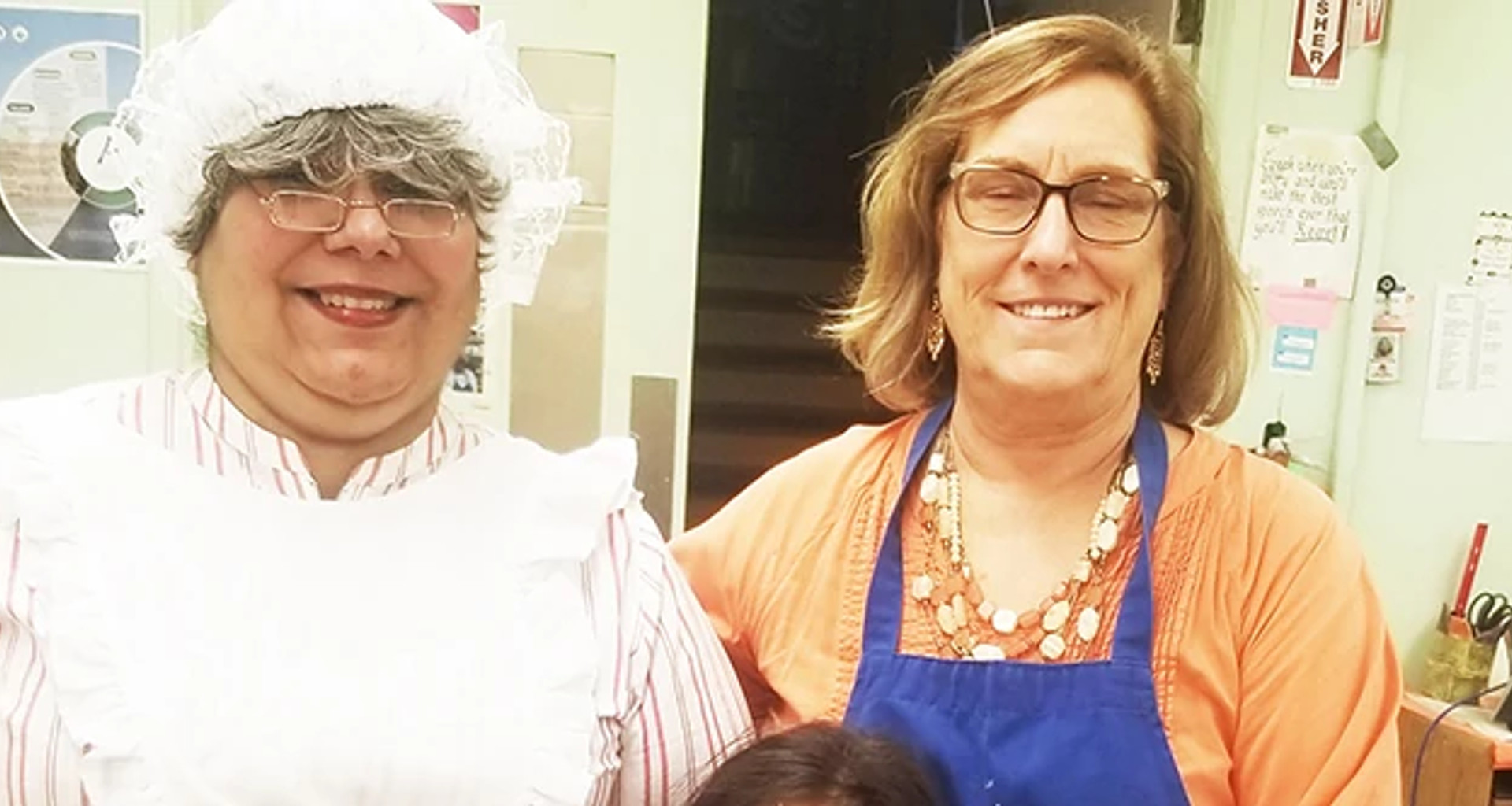 Older adult and woman in Ms Claus costume together